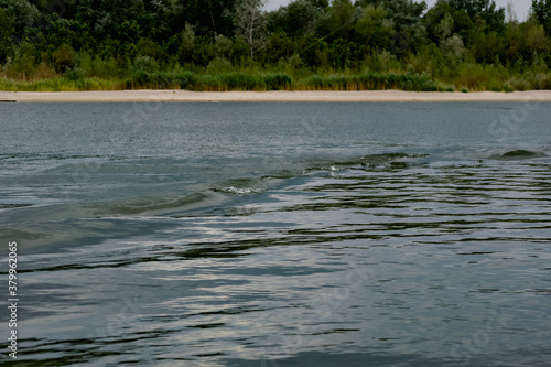 Simple landscape with the freshwater river don in the Rostov region. Warm season  summer  cloudy sky over the sandy beach and green vegetation. 