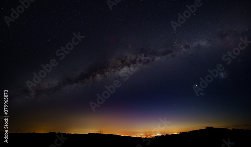 Night landscape with light from the city on the horizon. Elements of this image furnished by NASA.