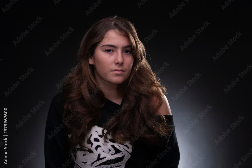 Fototapeta premium serious teenager, studio light, neutral background