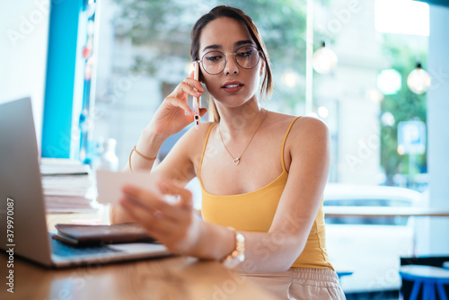 Focused young woman talking on cellphone Free Download Focused young woman talking on cellphone - GFXLoad