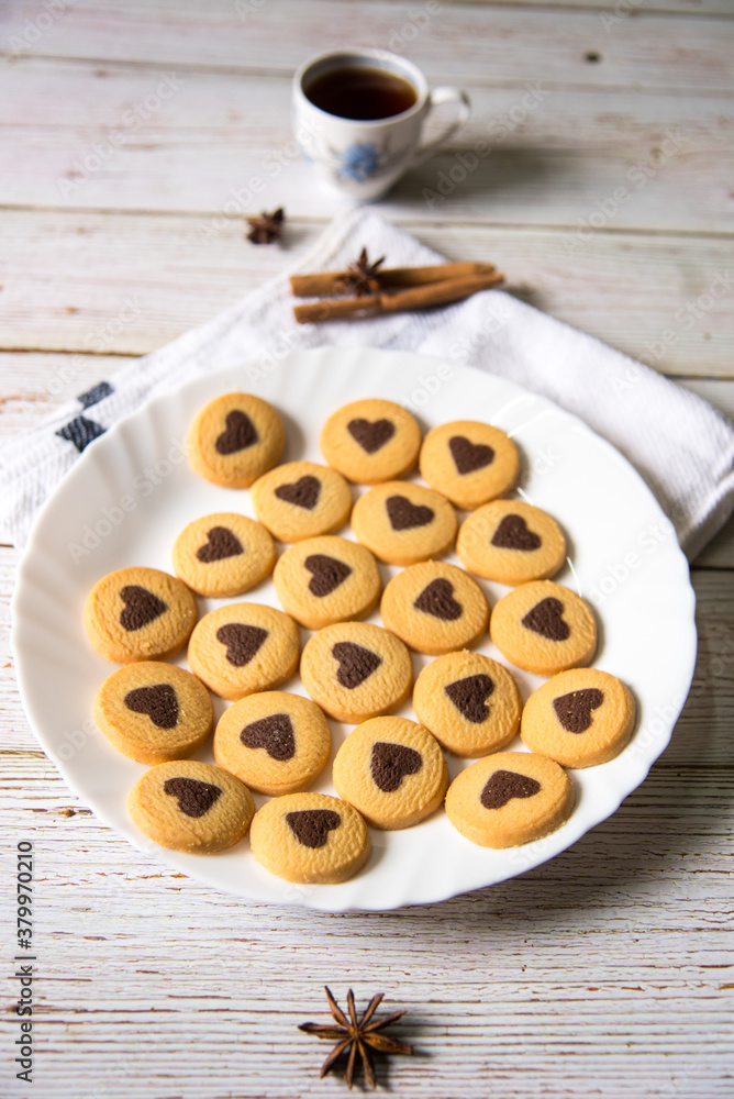 Vertical top view of fresh cookies with cinnamon sticks on a background Vertical top view of fresh cookies with cinnamon sticks on a background
