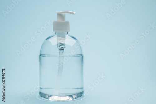 Dispenser of antibacterial gel on blue background
