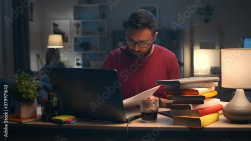 Man working with laptop at home in living room