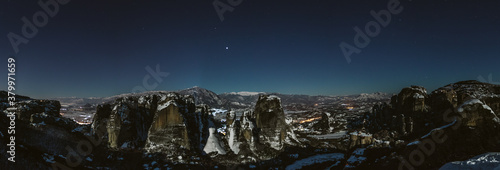 panoramashot of snowcovered mountain landscape in meteora at nightpanoramashot of snowcovered mountain landscape in meteora at night photo