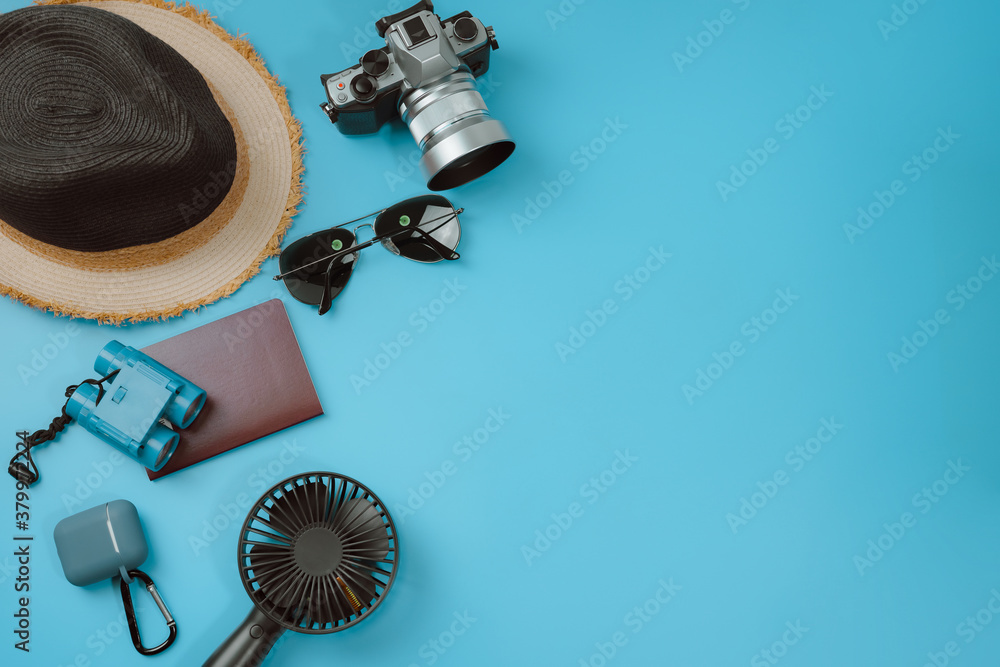 flat lay travel accessory in new normal with phone camera and passport on blue background - obrazy, fototapety, plakaty 