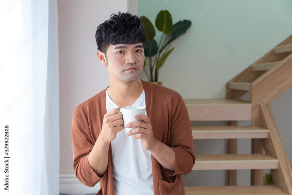 A handsome man wearing knitted coat holding a cup of coffee. Enjoy working day field recreation concept. A handsome man wearing knitted coat holding a cup of coffee. Enjoy working day field recreation concept.