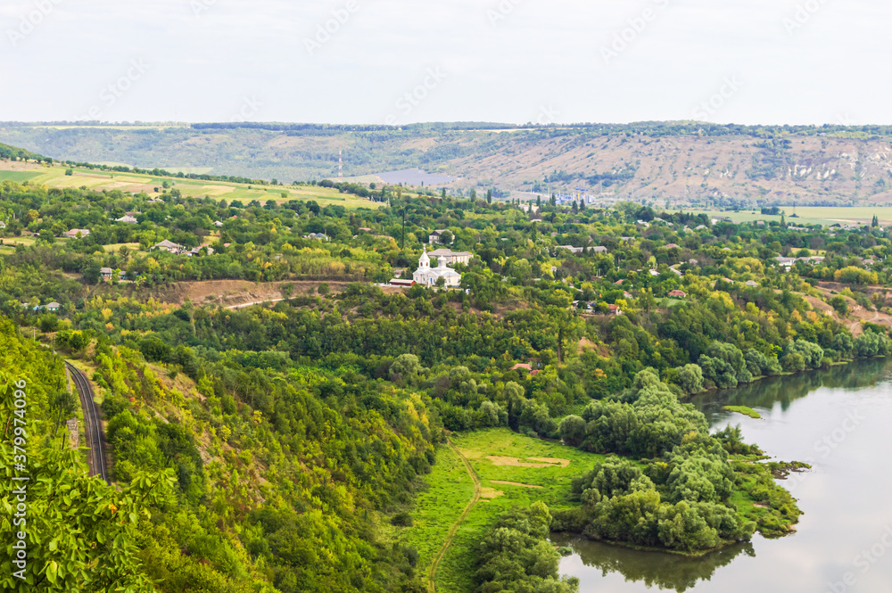 Obraz premium Moldavian village near the railway surrounded by forests on the banks of the Dniester River.
