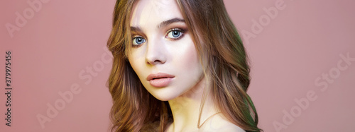 beauty portrait of young woman over pink background