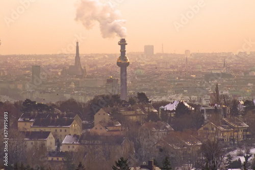 View of Vienna in the evening in winter, Austria. Waste recycling plant pipe in the centre