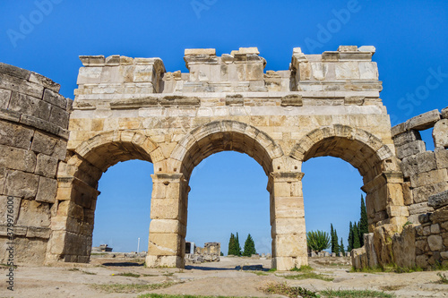 Facade of Domitian gates in antique city Hierapolis, Pamukkale, Turkey. Built in honor of Roman emperor in 84 AD. Travertine was used for decorative elements. Now included in UNESCO List