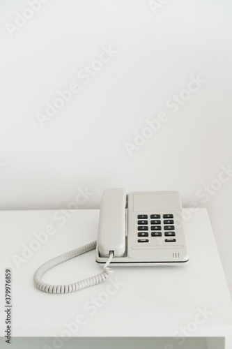 Push-button telephone with a receiver on a light background