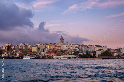 Panoramic view onto Karaköy quarter of Istanbul, Turkey from Golden Horn. There are Galata Tower, minarets of Ottoman mosques, neighbourship of old & modern buildings, tourist boats & local ferries. © Poliorketes