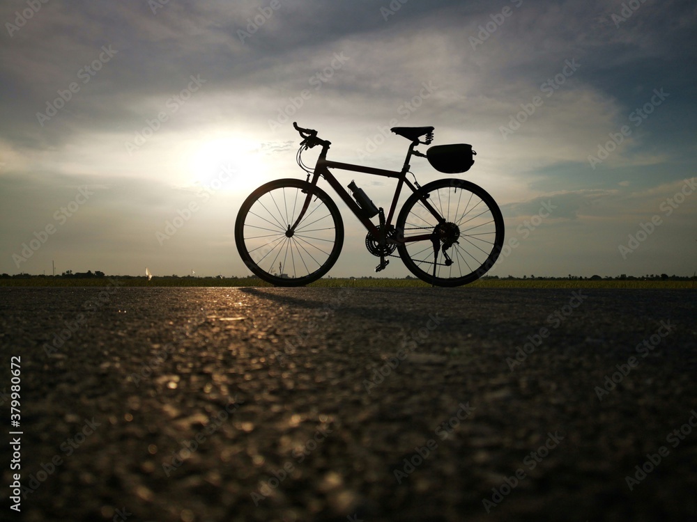 Fototapeta premium Silhouette photo of bike on the road