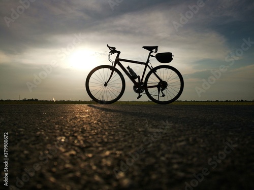 Fototapeta Naklejka Na Ścianę i Meble -  Silhouette photo of bike on the road
