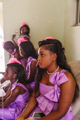 Five African bridesmaids wait for the ceremony to begin.