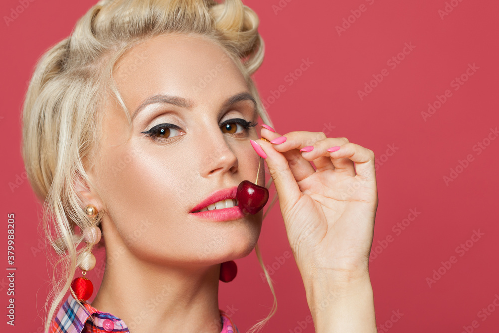 Young pin-up woman with make up eating cherry, close up portrait Young pin-up woman with make up eating cherry, close up portrait