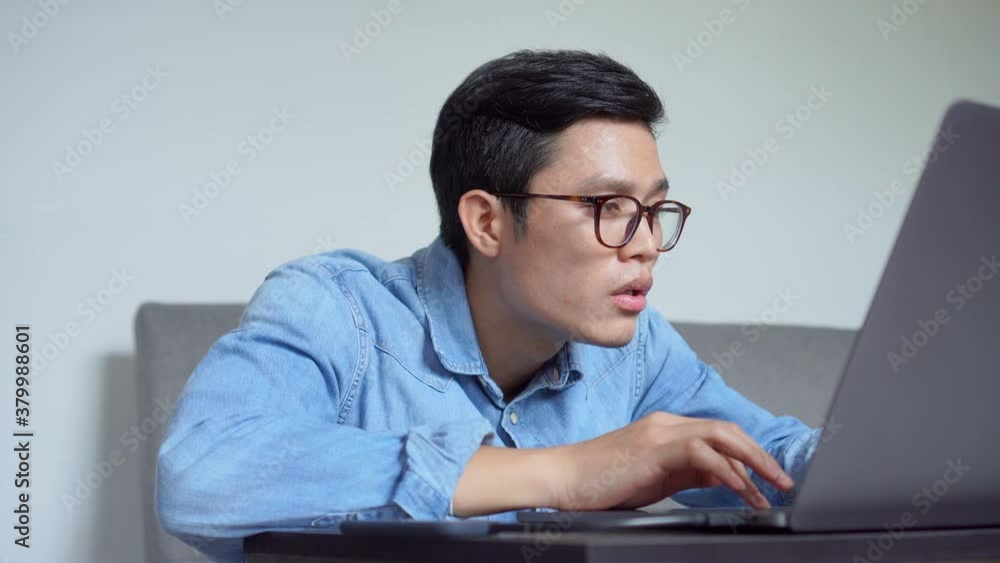 close up asian teenager man feeling bored while working at home office . millennial life concept close up asian teenager man feeling bored while working at home office . millennial life concept