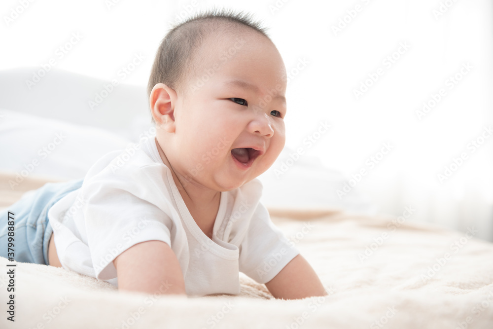 Portrait of a crawling baby on the bed. Happy asian infant in bedroom. Portrait of a crawling baby on the bed. Happy asian infant in bedroom.