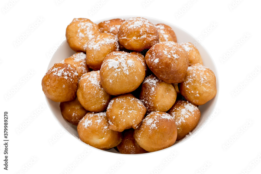 sweet donuts laid out pyramid sprinkled with powdered sugar on the plate