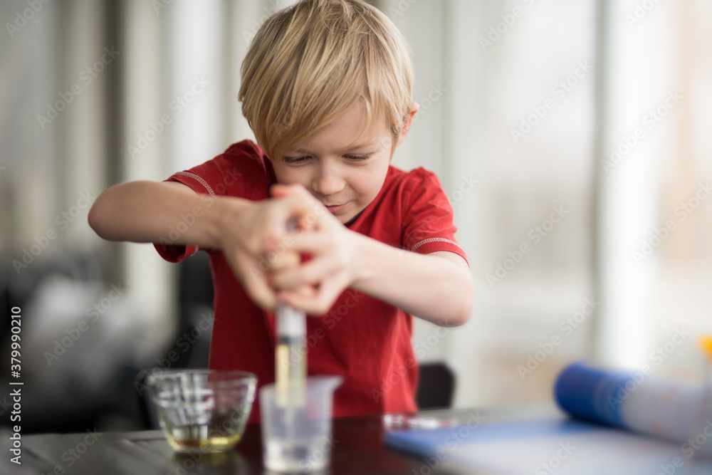 Little Boy Scientist Performing Experiment WIth Chemistry for Science Education Little Boy Scientist Performing Experiment WIth Chemistry for Science Education