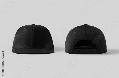 Black snapback caps mockup on a grey background, front and back side. photo