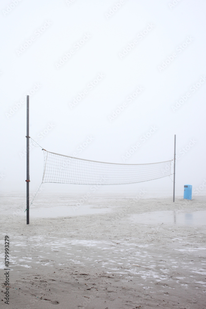 Volleyball net on a foggy beach in winter Volleyball net on a foggy beach in winter