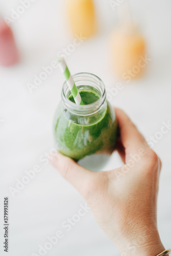 Woman holding green smoothie