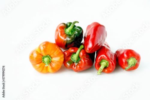 red,green and yellow peppers on white background