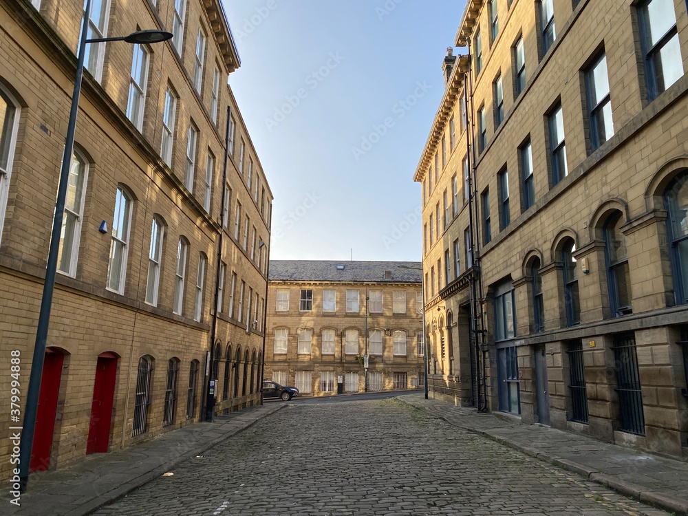 View on, Cater Street, at old textile buildings, built with Yorkshire stone, and with cobbled streets in, Little Germany, Bradford, UK
