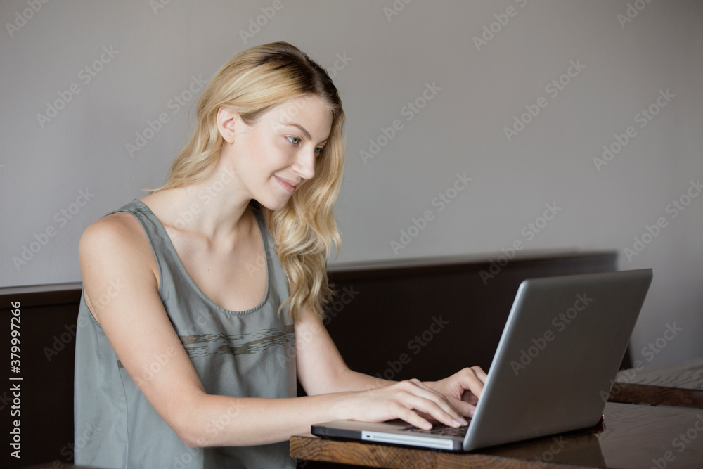 Caucasian woman using laptop at table Caucasian woman using laptop at table