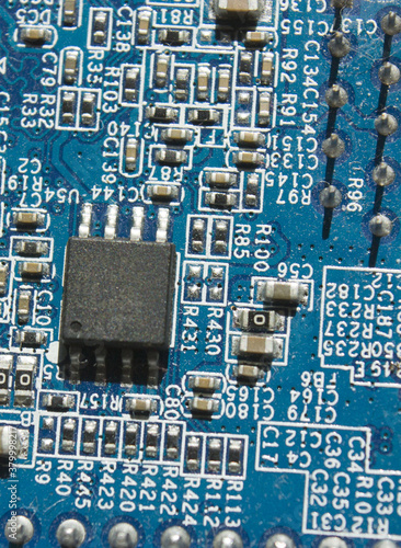 microchip and components on blue electronic pcb closeup