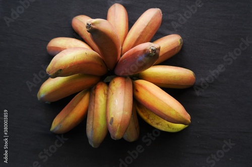 Bunch of red banana fruits ripened  isolated on black  background