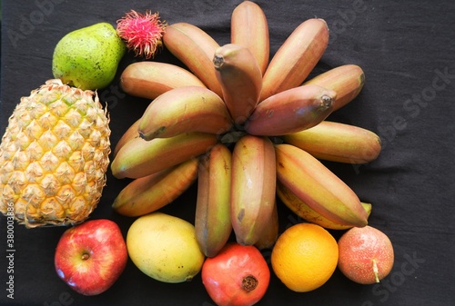 Healthy assorted natural fruits on black background ,top view,