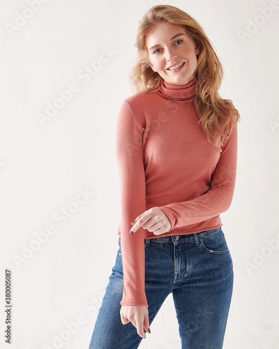 Young beautiful fashionable model posing in casual clothes in the studio.