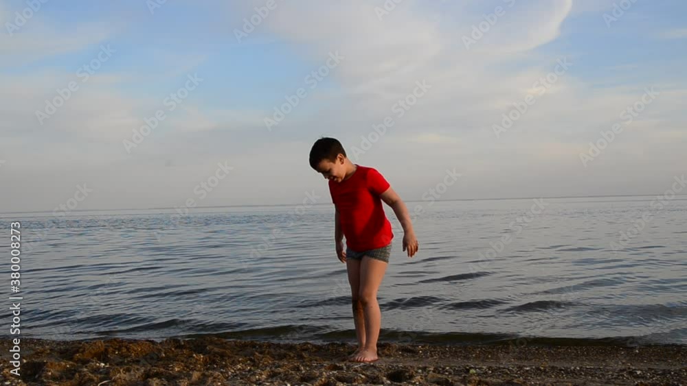 Kids playing on tropical beach. Children swim and play at sea on summer family vacation. Sand and water fun, sun protection for young child. Little boy running and jumping at ocean shore.