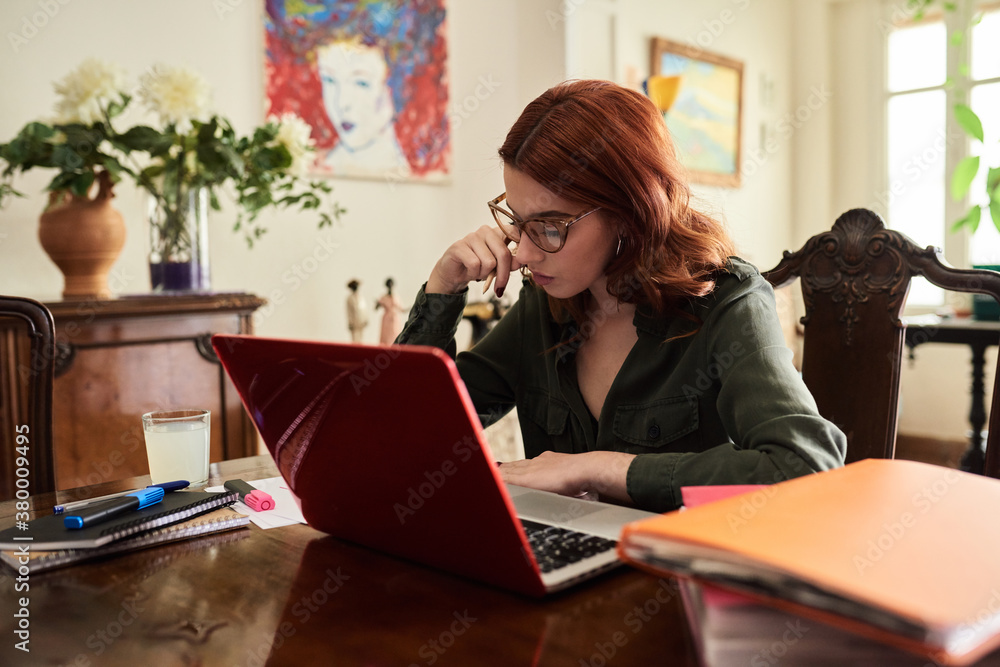 Busy teacher in glasses working at desk. Busy teacher in glasses working at desk.