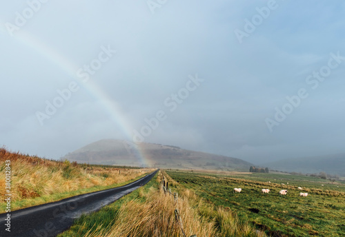 Rainbow over moorland road. Cockley Moor, Cumbria, UK. photo