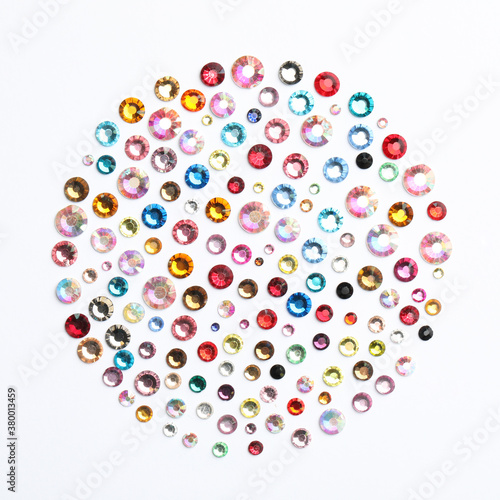 Different beautiful gemstones on white background, top view