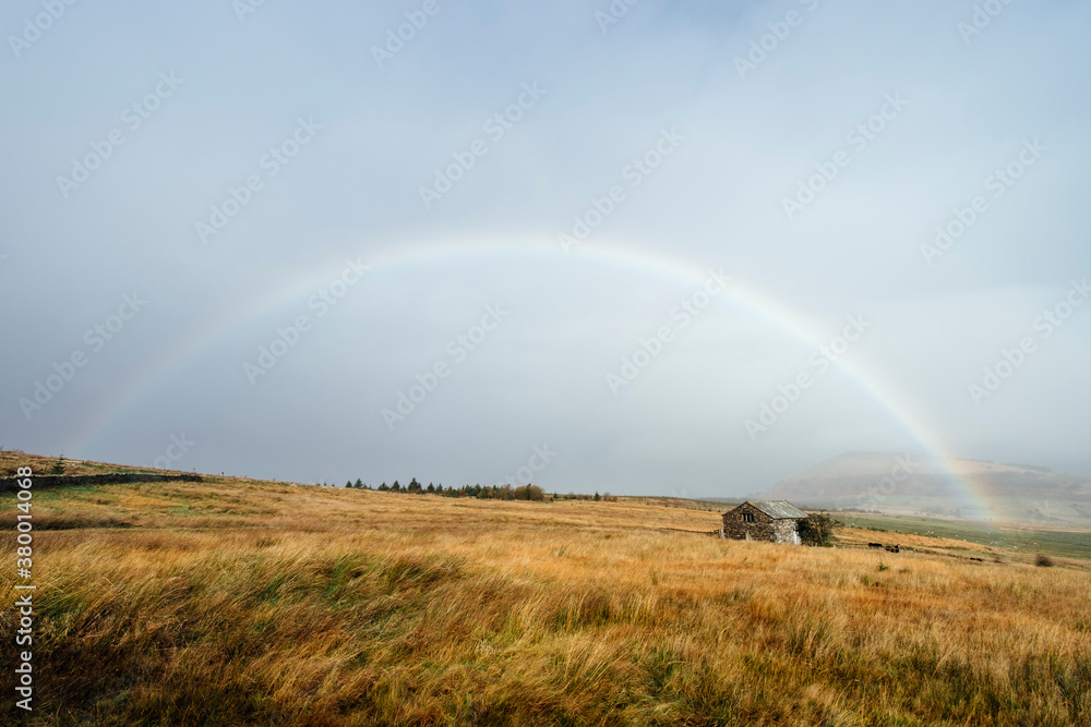 Rainbow over moorland and barn. Cockley Moor, Cumbria, UK. Rainbow over moorland and barn. Cockley Moor, Cumbria, UK.