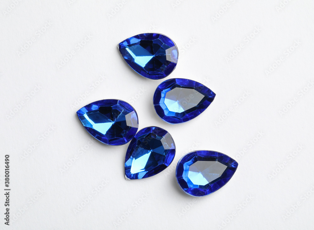 Beautiful gemstones on white background, top view Beautiful gemstones on white background, top view