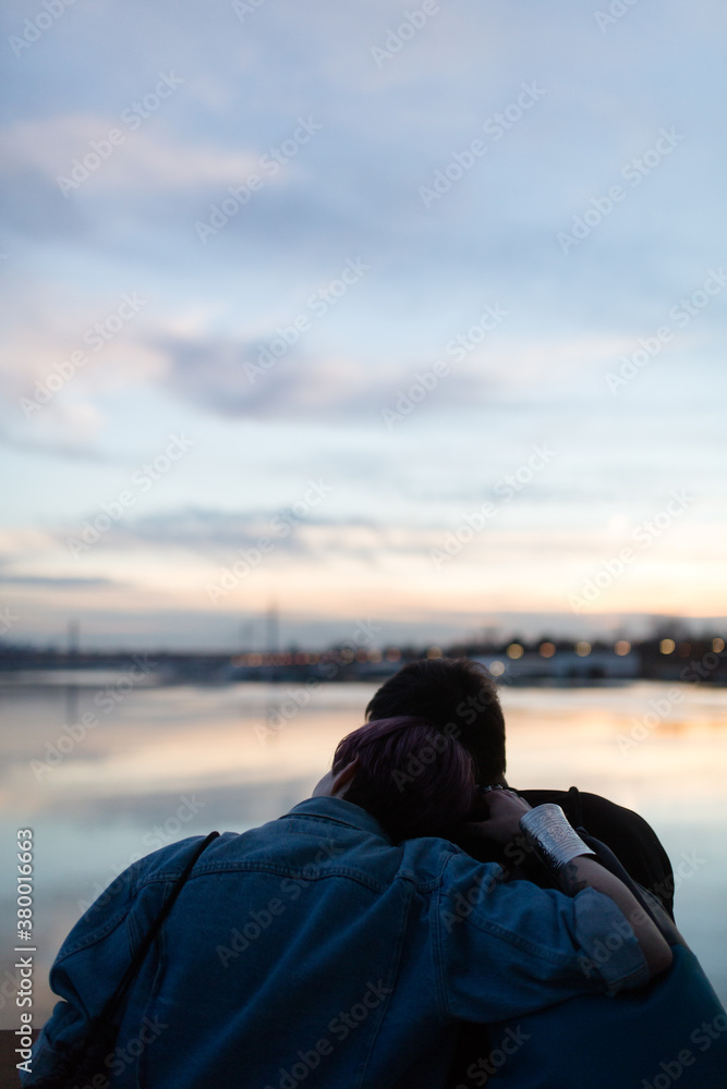 Couple sitting on the river bank Couple sitting on the river bank