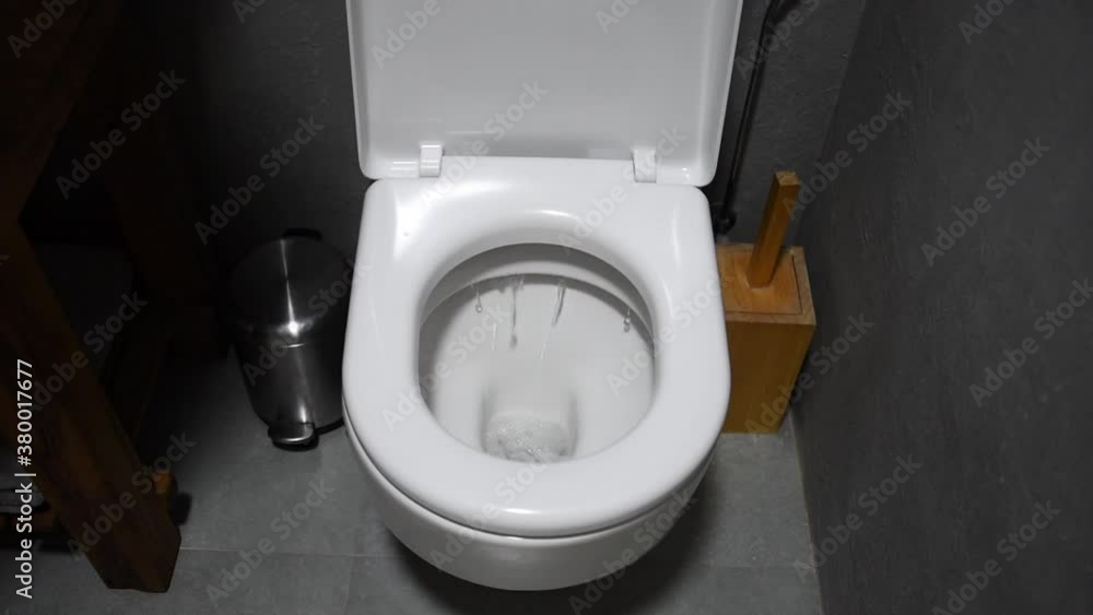 Toilet Flushed. Closeup view of water flushing down into the toilet