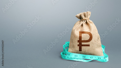 Russian ruble money bag and measuring tape meter. Analysis of economic situation. Assessment of capital. Declaration of income, illegal. Formation and optimization of the budget, savings.