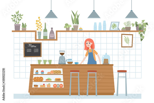 Woman barista behind counter bar of the coffee shop.