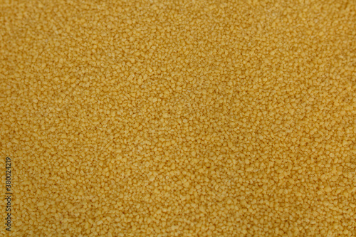 Raw organic couscous grains. Couscous background.