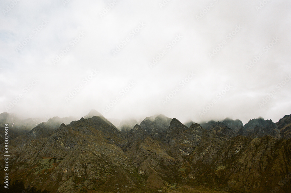 Jagged Green Cliffs Below Sky of Clouds Jagged Green Cliffs Below Sky of Clouds