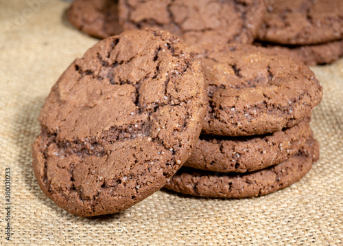 Shekoladno oatmeal cookies stacked on sackcloth concept homemade baking close up