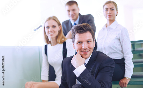 Business people sitting on the ladder in office