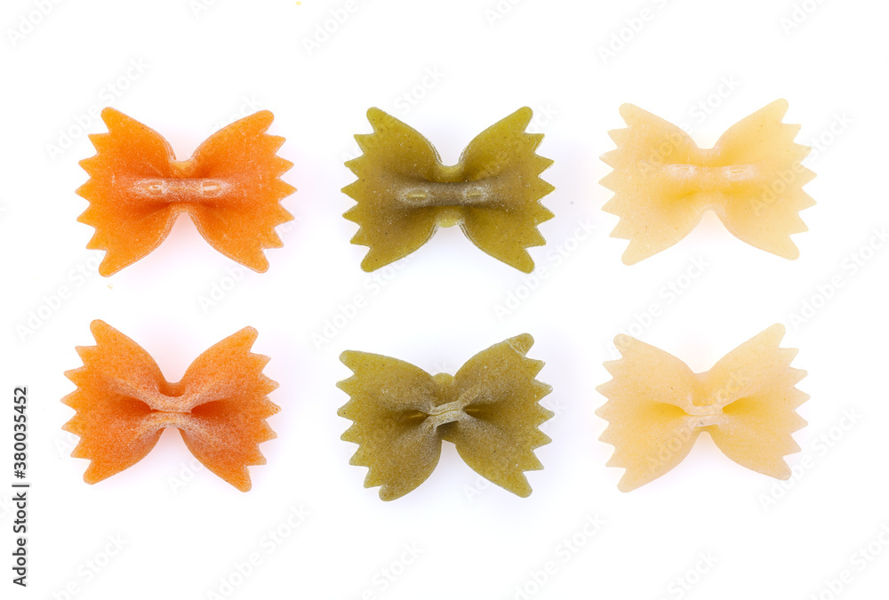 Color Farfalle - dry pasta isolated on a white background. A variety of types and forms of Italian pasta. Color Farfalle - dry pasta isolated on a white background. A variety of types and forms of Italian pasta.