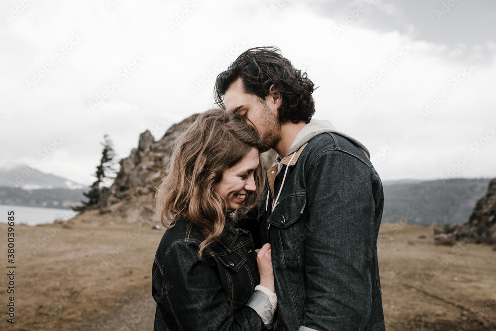 romantic couple embraces in beautiful landscape romantic couple embraces in beautiful landscape